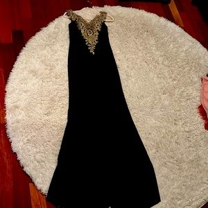 Long floor length black dress with gold sequenced top and back. Worn only once